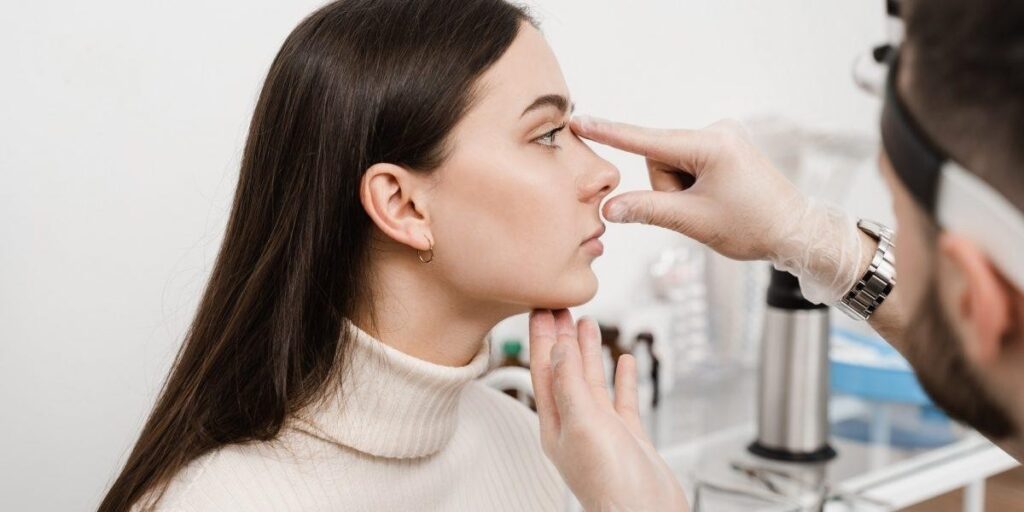 Nose Reshaping Surgery Procedure consultation showing a cosmetic surgeon evaluating nasal shape and facial proportions before rhinoplasty.