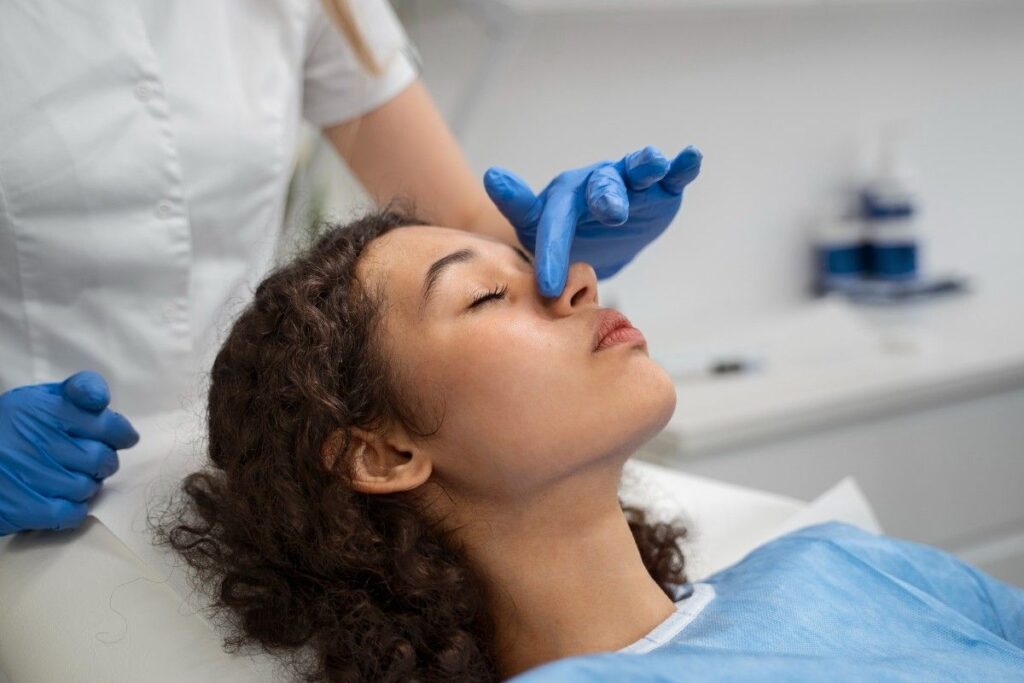 Benefits of rhinoplasty surgery consultation showing a patient undergoing nasal assessment before a personalized nose reshaping procedure.